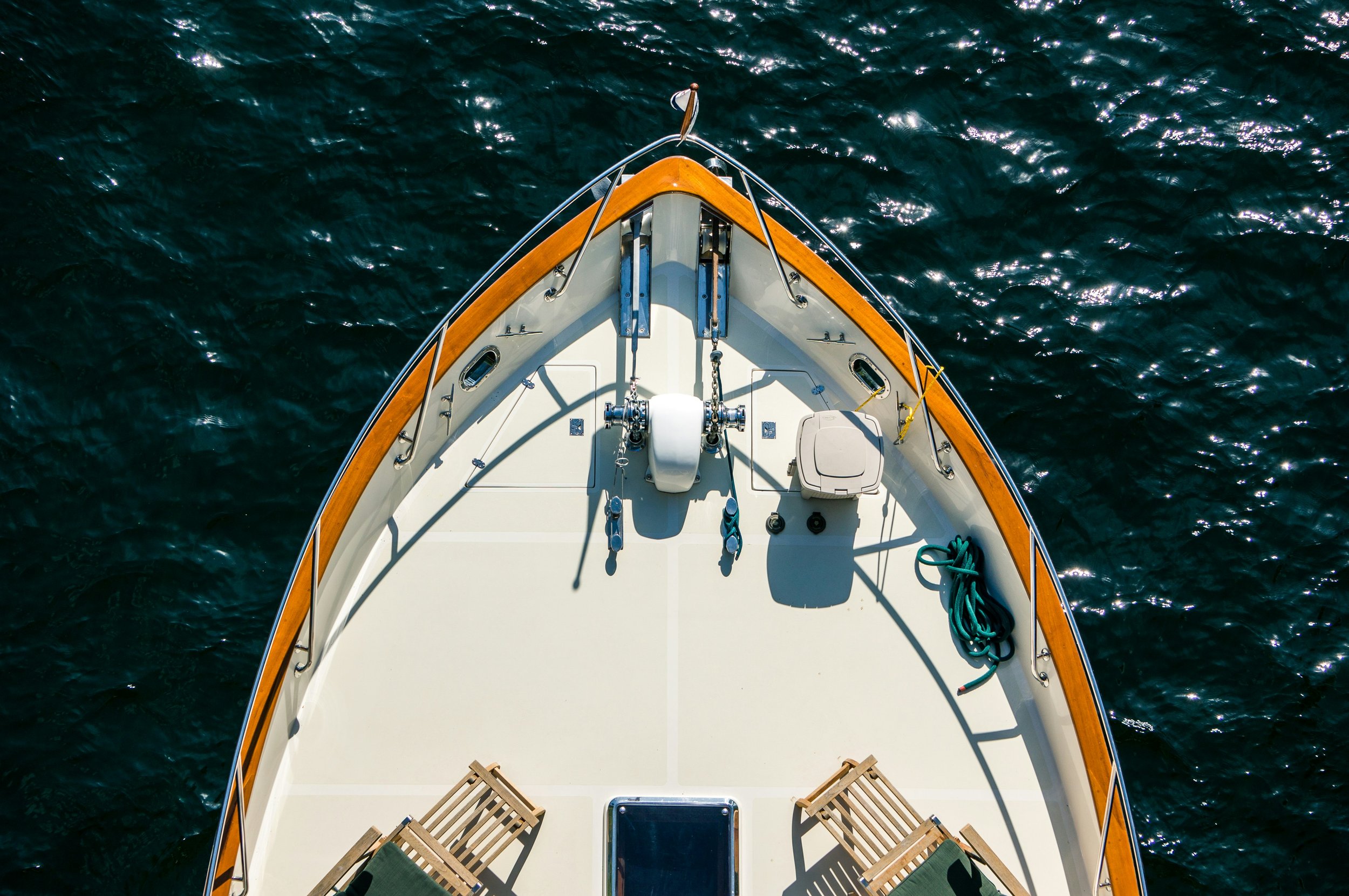 Boat floating over a bright coral reef in clear Red Sea water